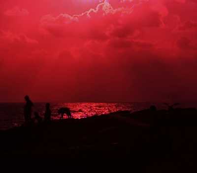 red - cloud and a kid standing and a dog